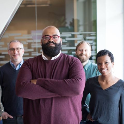 four grad students standing together