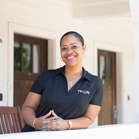 Reisha Kidd pictured on the porch of a transitional house
