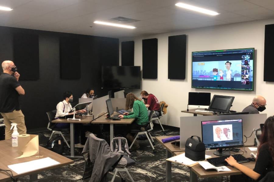 Bancroft works with students to animate a flashback scene in the series.