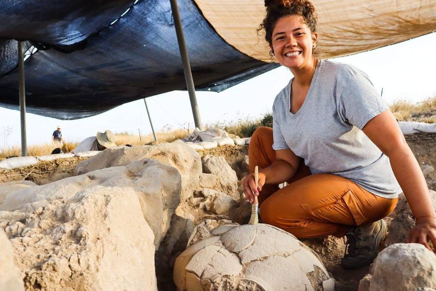 New Lipscomb graduate Evie Wilson brushes off a large storage jar during excavation work at the Lanier Center for Archaeology's Burna project in Israel. 