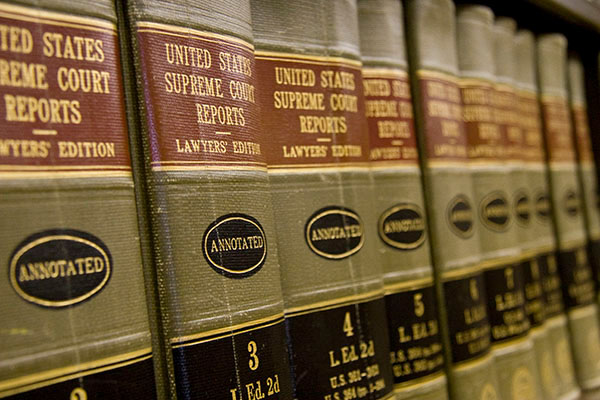 Multiple volumes of the United States Supreme Court Reports sit on a shelf