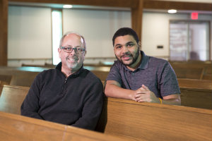 Randy Davis and LeBron Hill sit in pews at Wilson Avenue Church of Christ