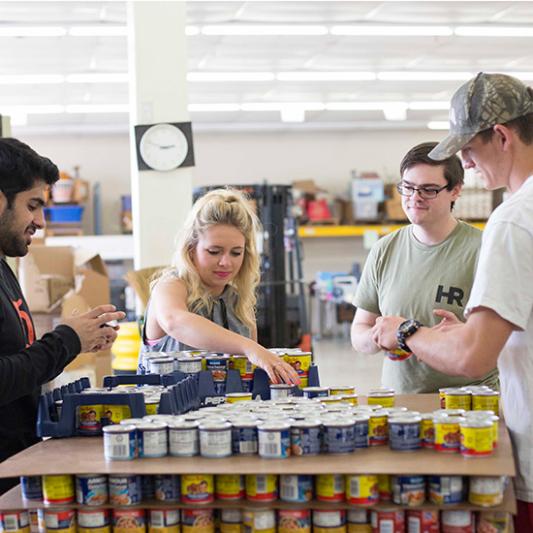 Students prepare cans of food for Service Day.