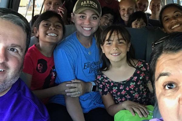 Softball students and coaches on a bus in the Baja