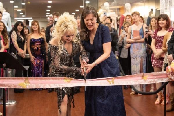Dolly Parton and Lipscomb President Candice McQueen cutting the ribbon to open the exhibit