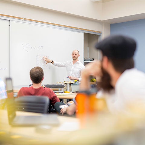 Students listen to a professor in engineering class