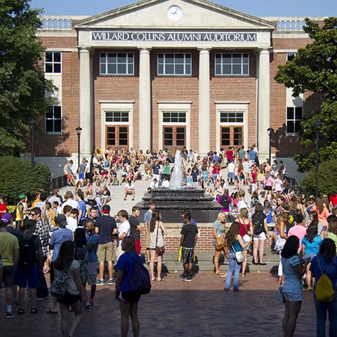 students in front of campus building