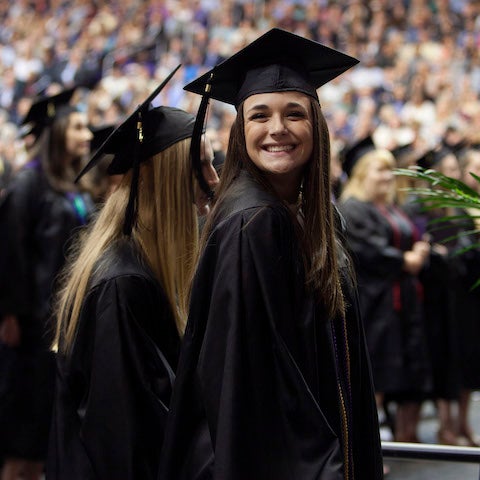 Student smiles at graduation.