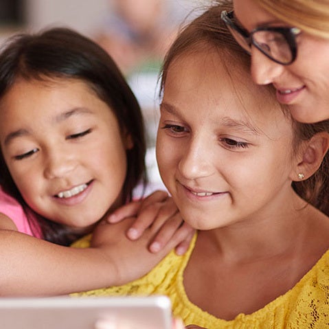 Teacher helping elementary students