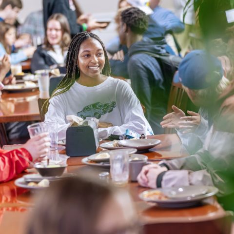 Girl eating with friends at the cafeteria