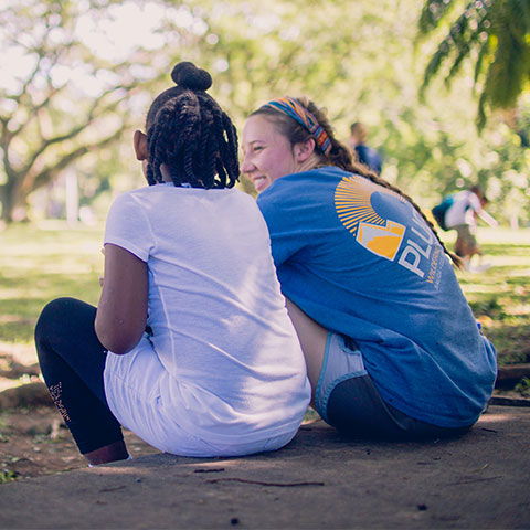 Student talks with a local girl during a mission trip.