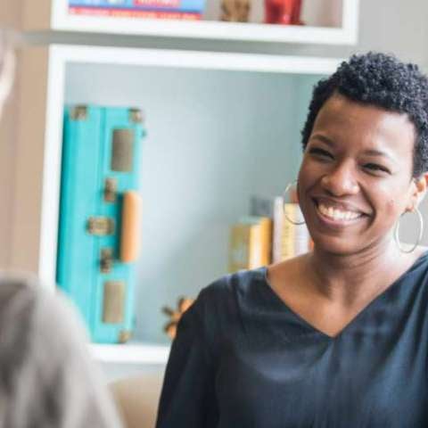 client in a therapy session, smiling