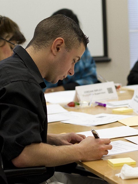 students writing at table