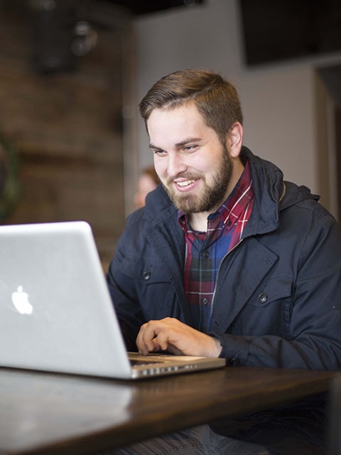 student at table with laptop