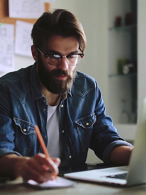 student at table with laptop