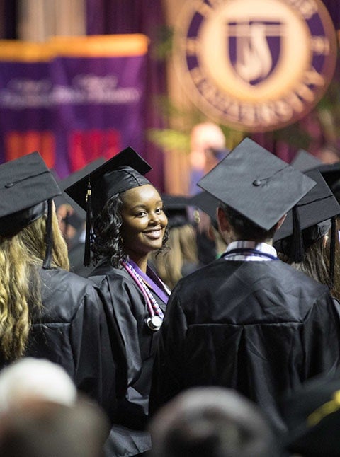 students at graduation in caps and gowns