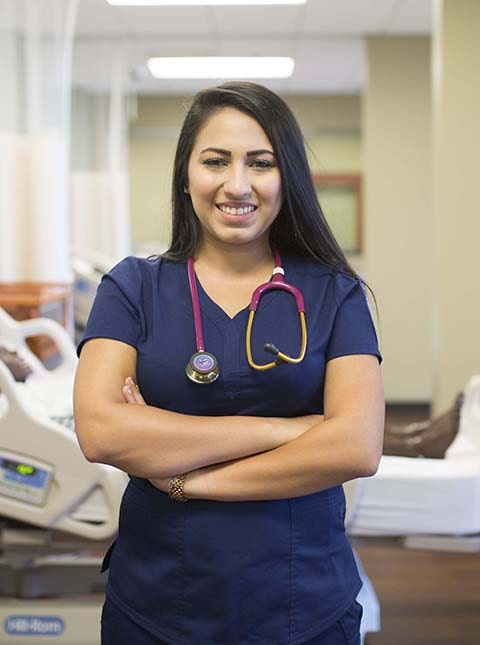 student in blue scrubs in a hospital