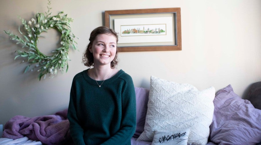 Emma Dryden sitting in dorm room