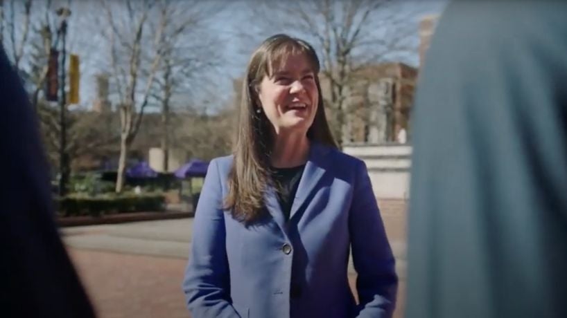 Dr. McQueen smiling as she talks to two students