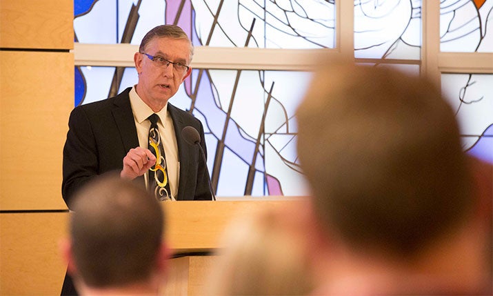 Dean Leonard Allen speaks in front of group in Ezell Chapel.