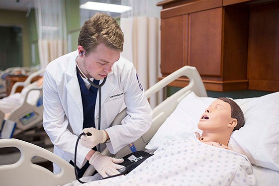 A student nurse helps his "patient".