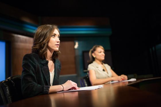 News anchors at desk.