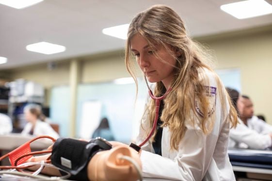 Student pharmacist hands-on learning.