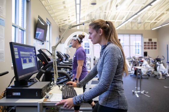 A student works with a staff member in the Student Activities Center.