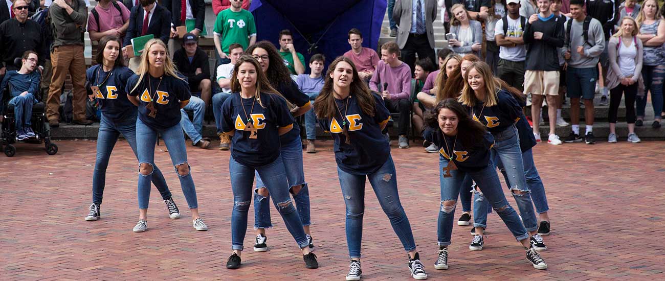 Students gather in Bison Square to watch pledges perform.