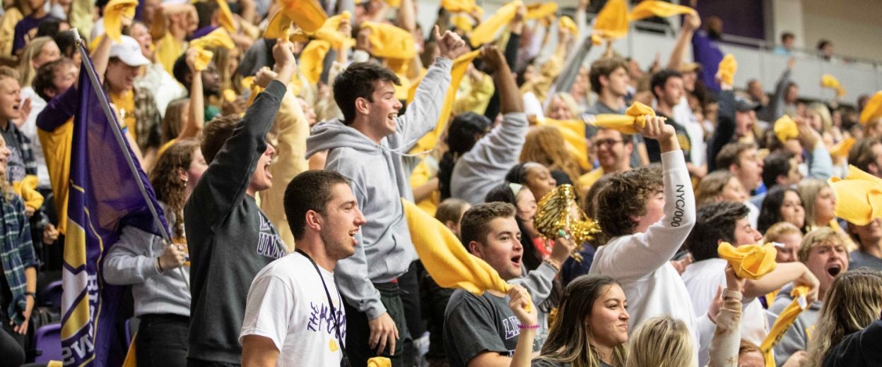 Crowd of students cheering at a basketball game