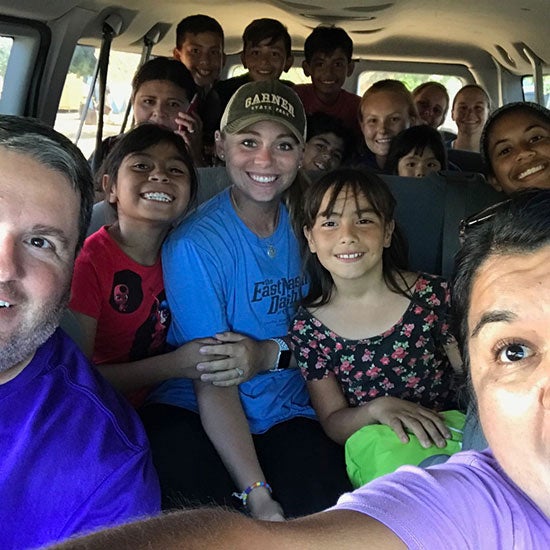 Softball students and coaches on a bus in the Baja