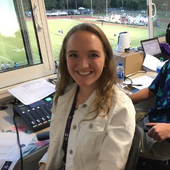 Erika Plunkett in football broadcast booth.