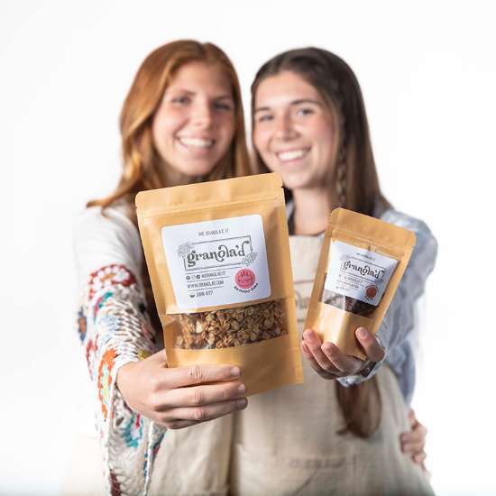 Anna Belle and Lila Mae Skidmore holding up their granola product