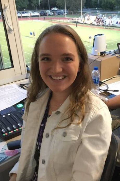 Erika Plunkett in football broadcast booth.