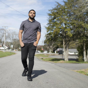 LeBron Hill walks outside near the Shepherd’s House where he lived after being homeless.