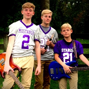 Three young boys with guitars.