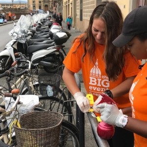 Two girls cleaning bikes. 