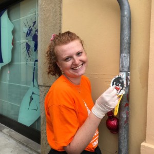 Girl smiling and cleaning pipe