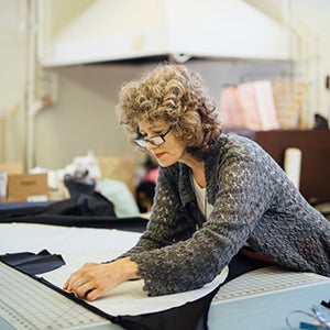 June Kingsbury working in the costume shop