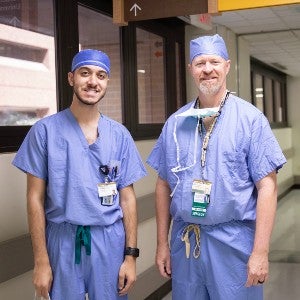 Timothy Khalil, 2023 Ward fellow, and Dr. Eric Grogan just outside the surgery room