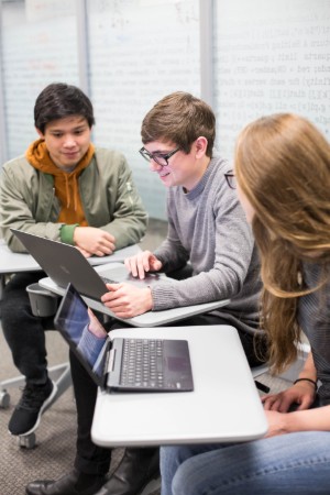 Students studying around a computer