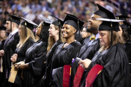 Graduates wait to receive their degrees