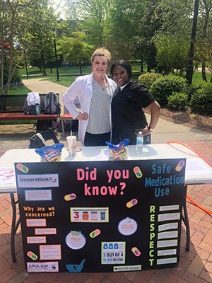 Pharmacy students at education booth on campus