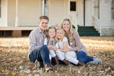 Brandon Lokey in a family portrait with his wife and two daughters.