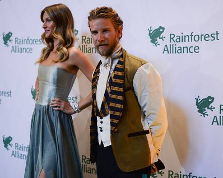 Jeff Garner on red carpet with model wearing one of his designs.