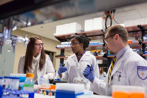 pharmacy students and faculty in a lab