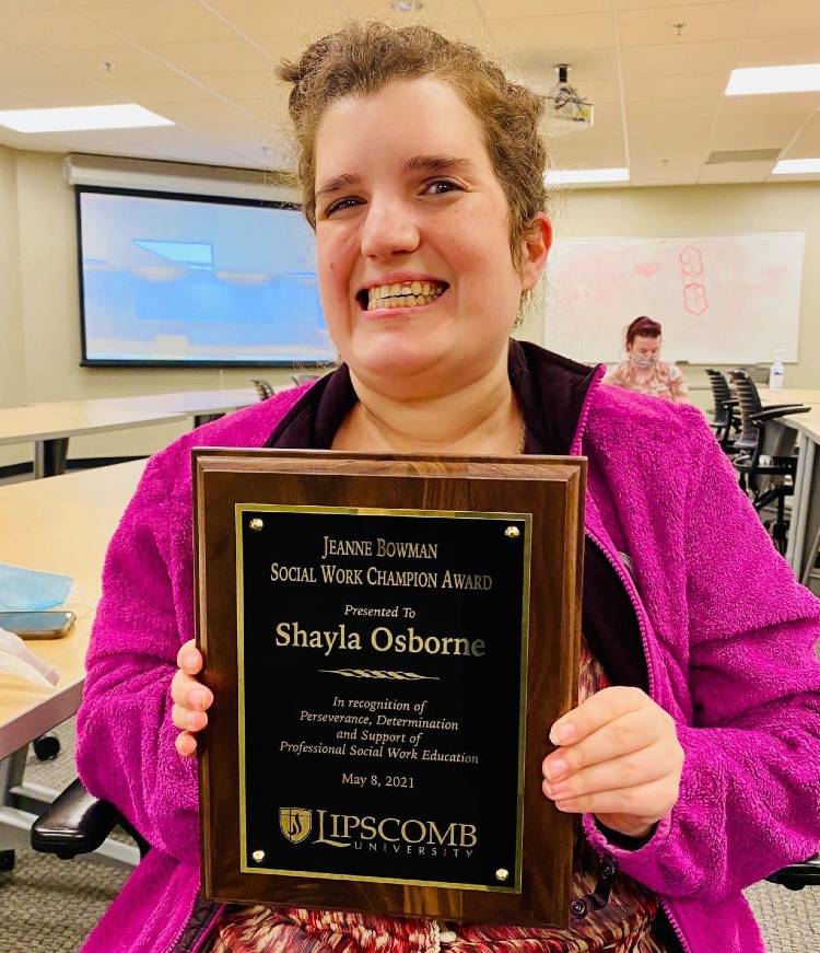 Shayla Osborne holding Bowman plaque.