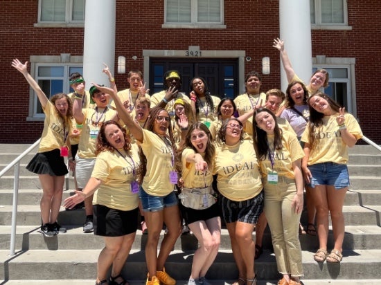 IDEAL Summer Academy Campers and Counselors posing together on stairs