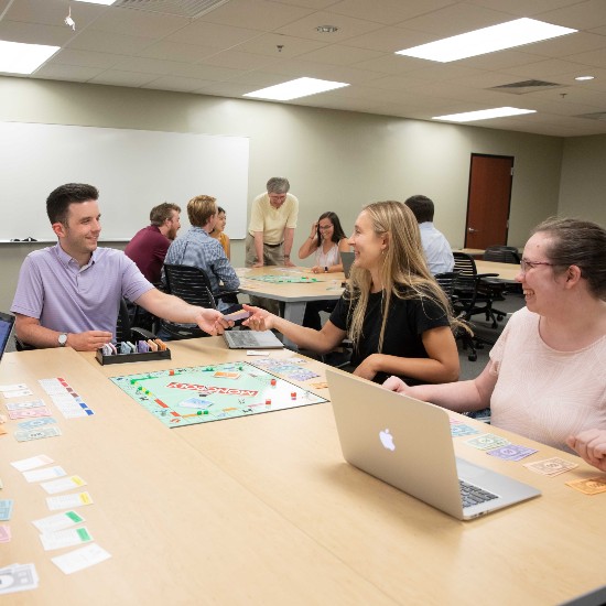 Business Students Play Monopoly with a spin