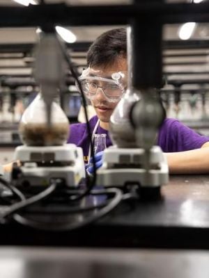 Student conducts a chemistry experiment 